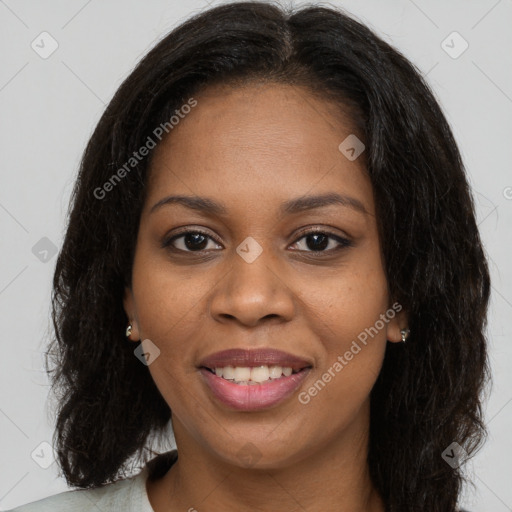 Joyful black young-adult female with long  brown hair and brown eyes