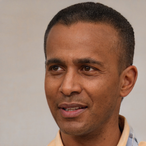 Joyful latino adult male with short  brown hair and brown eyes