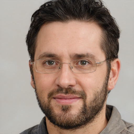 Joyful white adult male with short  brown hair and brown eyes