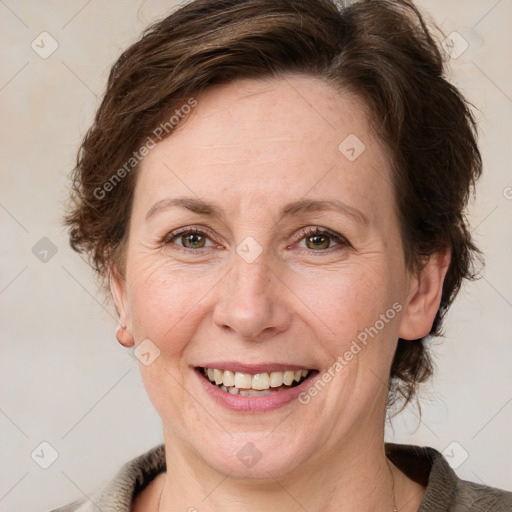 Joyful white adult female with medium  brown hair and green eyes