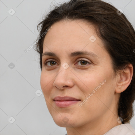 Joyful white adult female with medium  brown hair and brown eyes