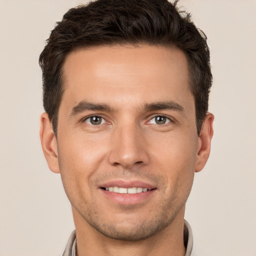 Joyful white young-adult male with short  brown hair and brown eyes