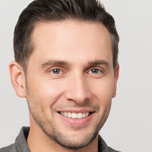 Joyful white young-adult male with short  brown hair and brown eyes