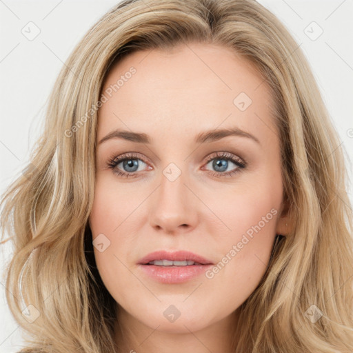 Joyful white young-adult female with long  brown hair and blue eyes