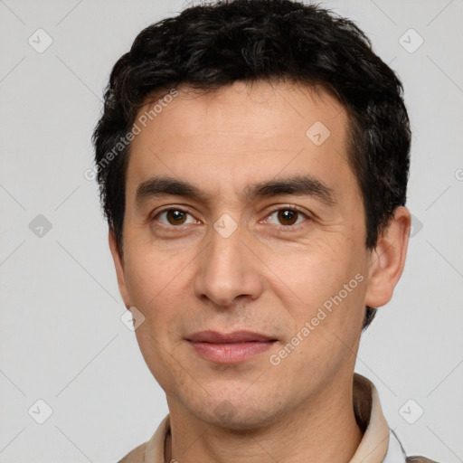 Joyful white adult male with short  black hair and brown eyes