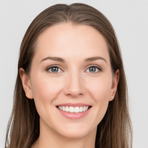 Joyful white young-adult female with long  brown hair and grey eyes