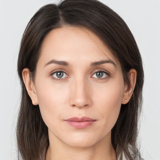 Neutral white young-adult female with long  brown hair and brown eyes