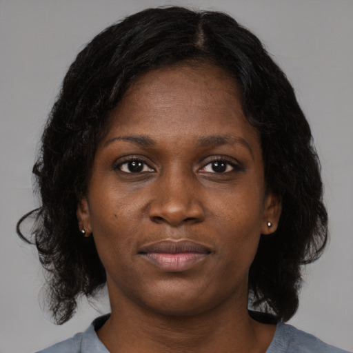 Joyful black young-adult female with medium  brown hair and brown eyes