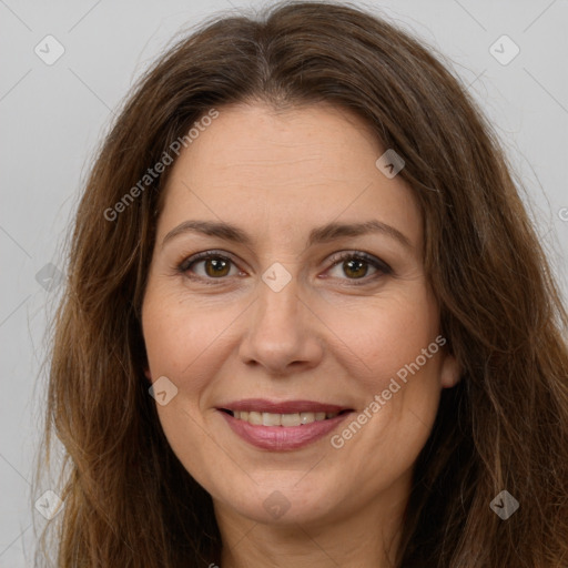 Joyful white adult female with long  brown hair and brown eyes