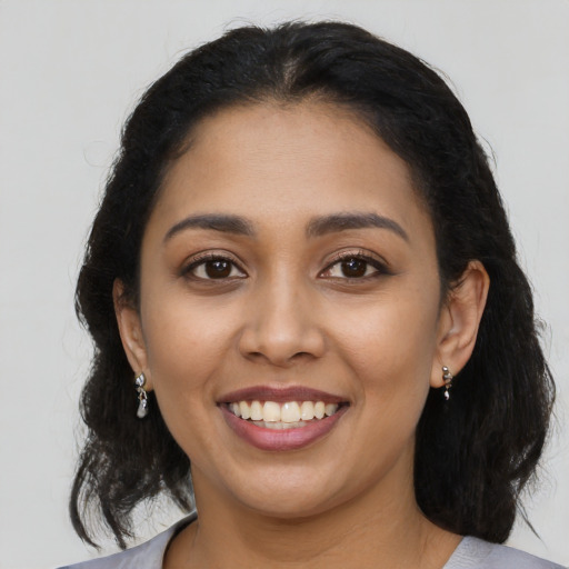 Joyful latino young-adult female with long  black hair and brown eyes