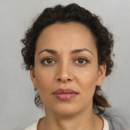 Joyful latino adult female with short  brown hair and brown eyes