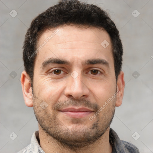 Joyful white adult male with short  brown hair and brown eyes