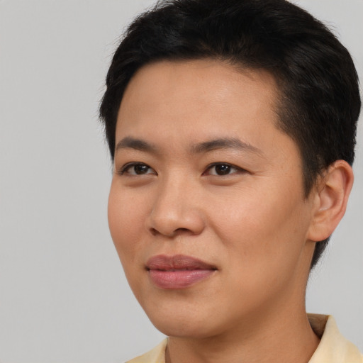 Joyful asian young-adult male with short  black hair and brown eyes