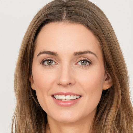 Joyful white young-adult female with long  brown hair and brown eyes