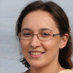 Joyful white adult female with medium  brown hair and grey eyes