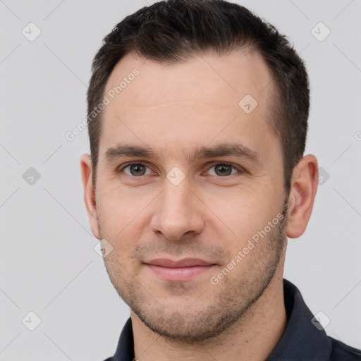 Joyful white young-adult male with short  brown hair and brown eyes