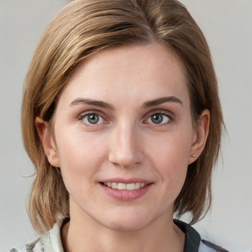 Joyful white young-adult female with medium  brown hair and blue eyes