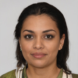 Joyful latino young-adult female with medium  brown hair and brown eyes