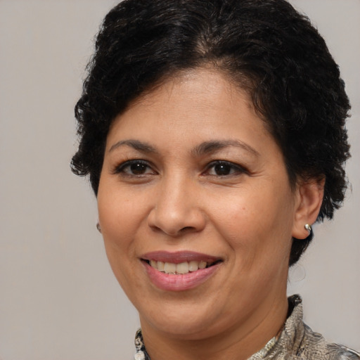 Joyful latino adult female with short  brown hair and brown eyes