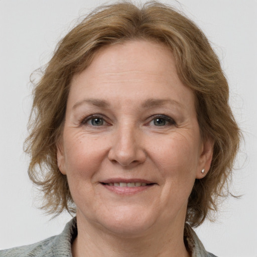 Joyful white adult female with medium  brown hair and blue eyes