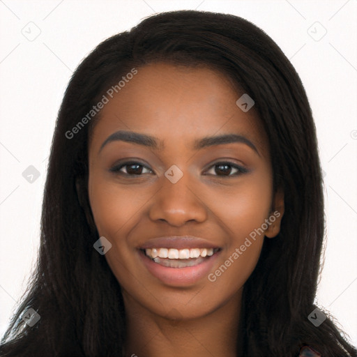 Joyful black young-adult female with long  brown hair and brown eyes