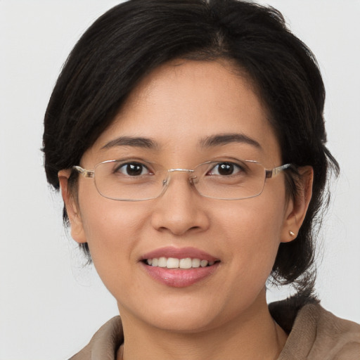 Joyful white young-adult female with medium  brown hair and brown eyes