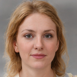 Joyful white young-adult female with medium  brown hair and blue eyes