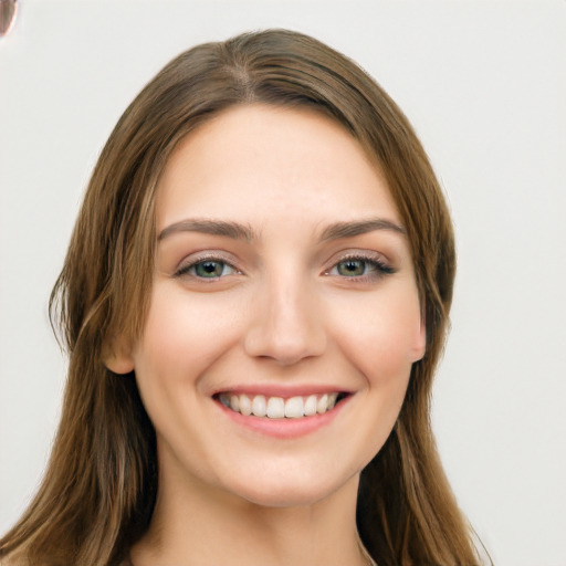 Joyful white young-adult female with long  brown hair and green eyes