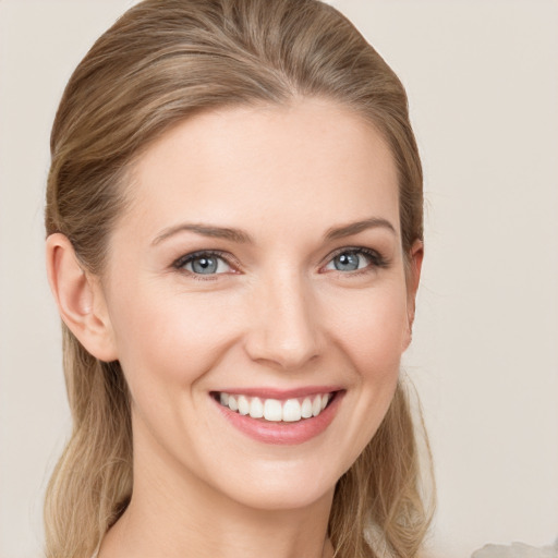 Joyful white young-adult female with long  brown hair and grey eyes