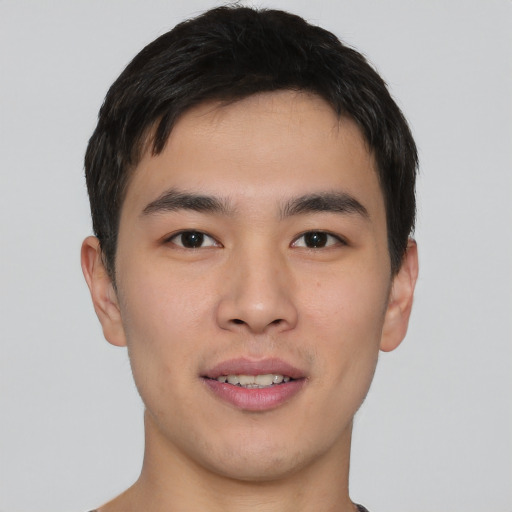 Joyful asian young-adult male with short  brown hair and brown eyes