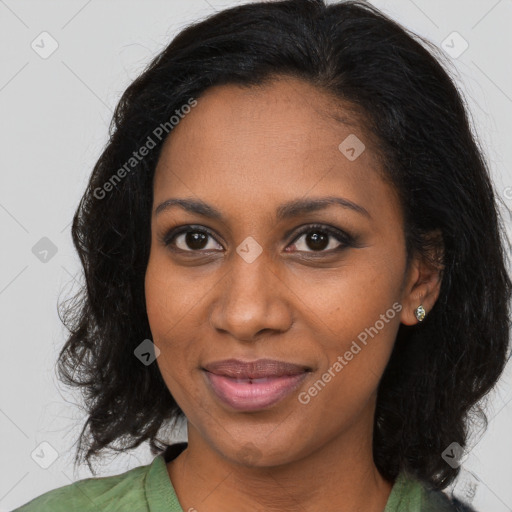 Joyful black young-adult female with long  brown hair and brown eyes