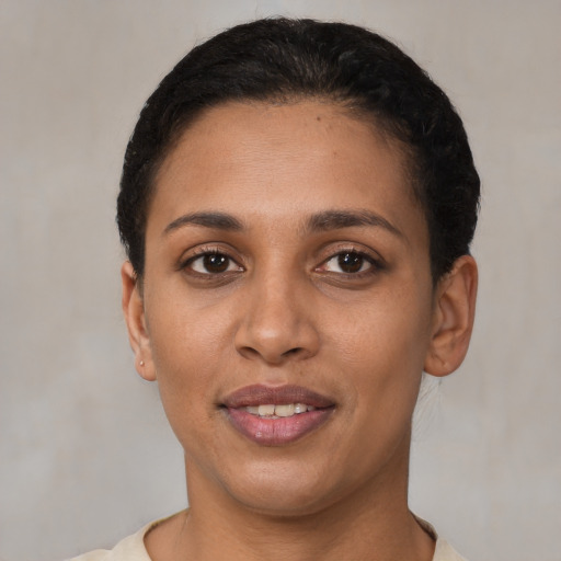 Joyful latino young-adult female with short  black hair and brown eyes