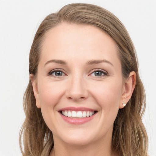 Joyful white young-adult female with long  brown hair and blue eyes