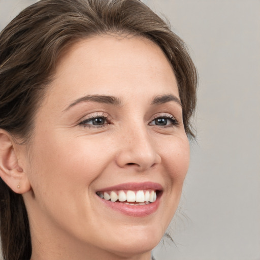 Joyful white young-adult female with medium  brown hair and brown eyes