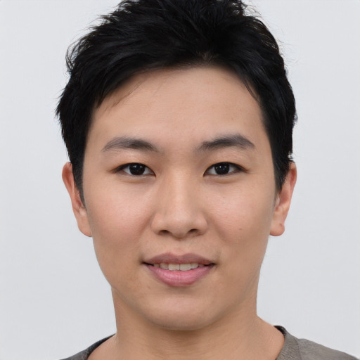 Joyful asian young-adult female with short  black hair and brown eyes