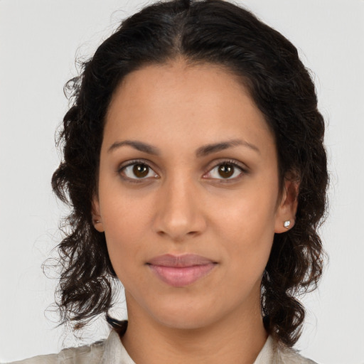 Joyful latino young-adult female with medium  brown hair and brown eyes