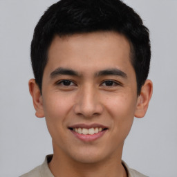 Joyful asian young-adult male with short  black hair and brown eyes