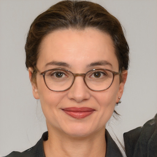 Joyful white adult female with medium  brown hair and brown eyes