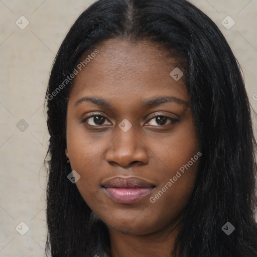 Joyful black young-adult female with long  black hair and brown eyes