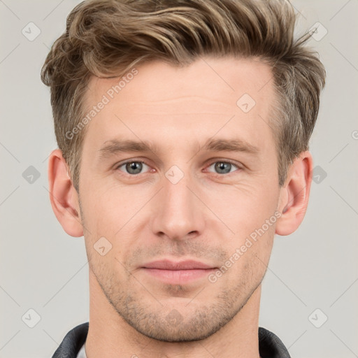 Joyful white young-adult male with short  brown hair and grey eyes