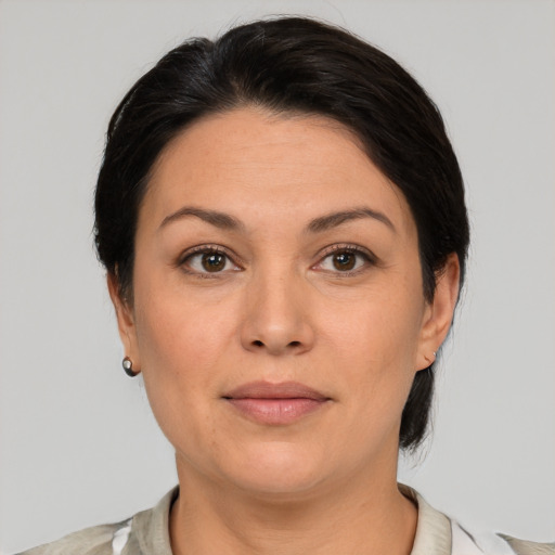 Joyful white adult female with medium  brown hair and brown eyes