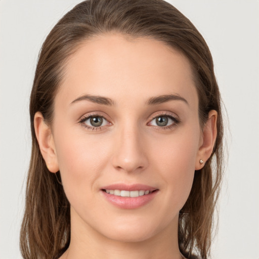 Joyful white young-adult female with long  brown hair and grey eyes