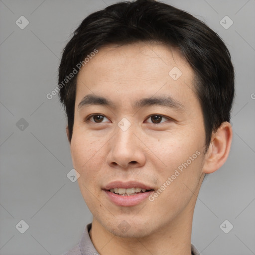 Joyful asian young-adult male with short  brown hair and brown eyes