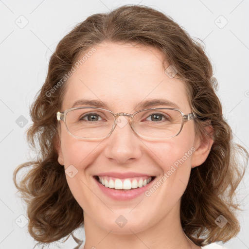 Joyful white adult female with medium  brown hair and green eyes