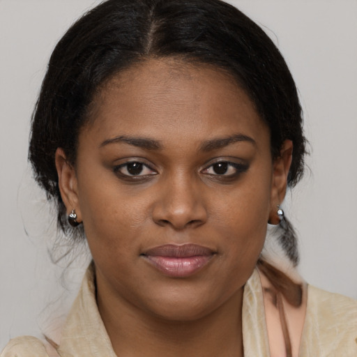 Joyful black young-adult female with medium  brown hair and brown eyes