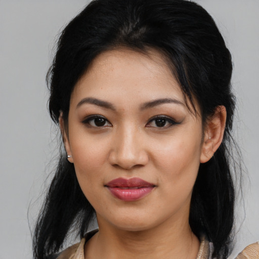 Joyful latino young-adult female with medium  black hair and brown eyes