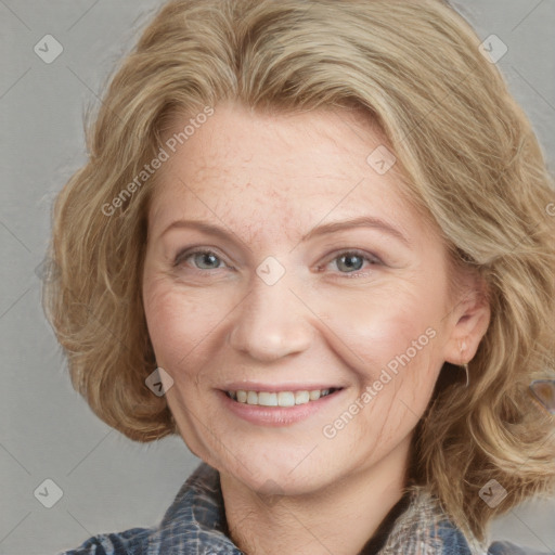 Joyful white adult female with medium  brown hair and blue eyes