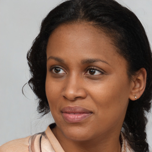 Joyful black young-adult female with medium  brown hair and brown eyes