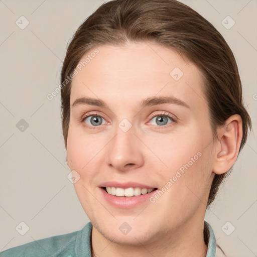 Joyful white young-adult female with short  brown hair and grey eyes