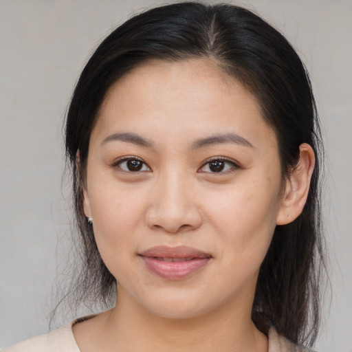 Joyful asian young-adult female with medium  brown hair and brown eyes